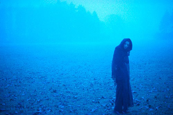 Woman standing in a foggy clearing